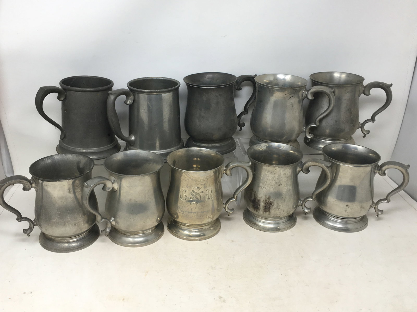 Group of (10) Steiff Pewter Mugs: Group of (10) Steiff Pewter Mugs. (8) Williamsburg pattern, 1 monogrammed Hyde Park C.C. 1973, 1 is marked Lenox Kirk Steiff pewter and monogrammed CSR; (2) straight sided tankards, one with glass bot