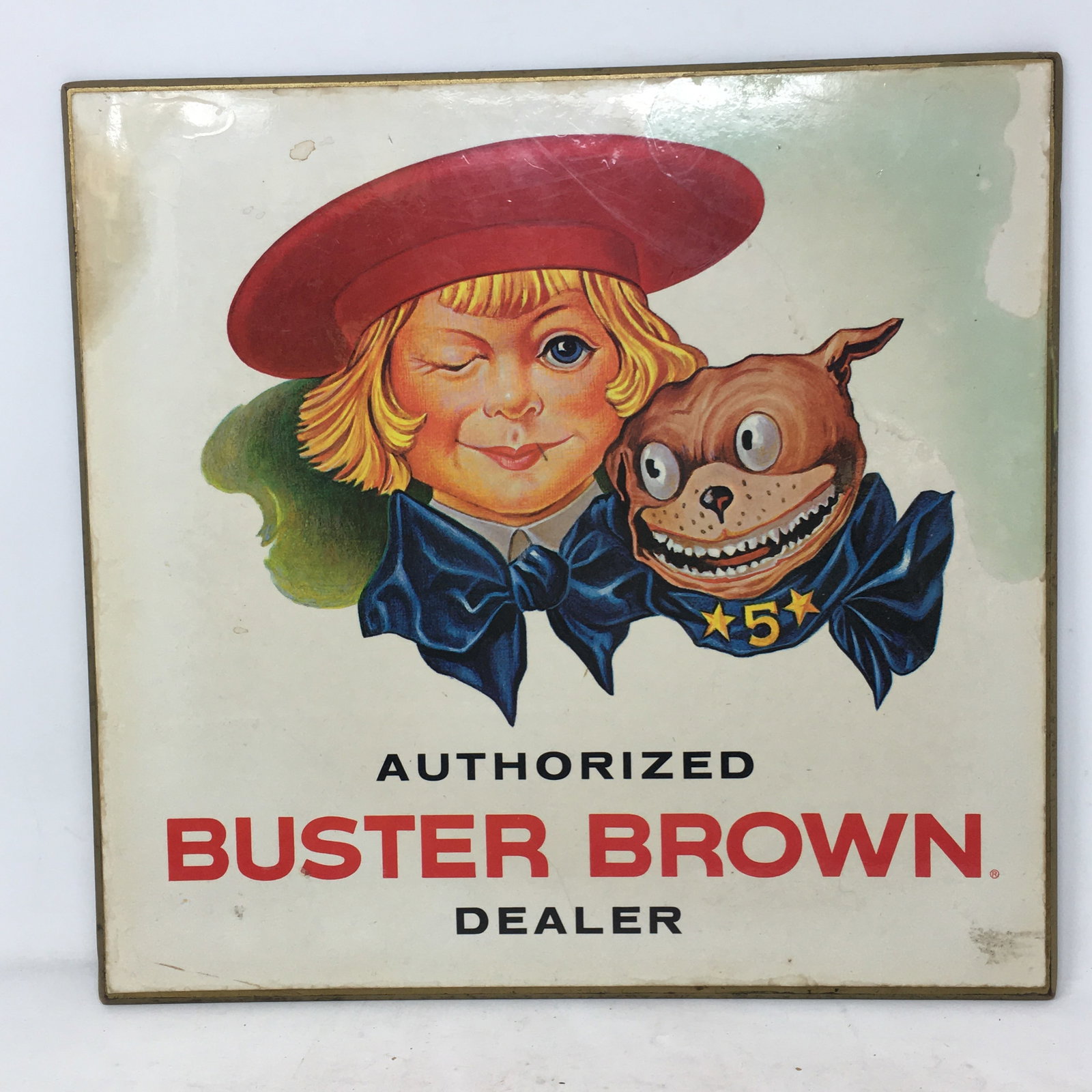 Buster Brown Shoe Dealer Stand Up Sign: Buster Brown Shoe Dealer Stand Up Sign. "Authorized Buster Brown Dealer". Laminated paper on masonite with cardboard standup. 14" x 14.5".