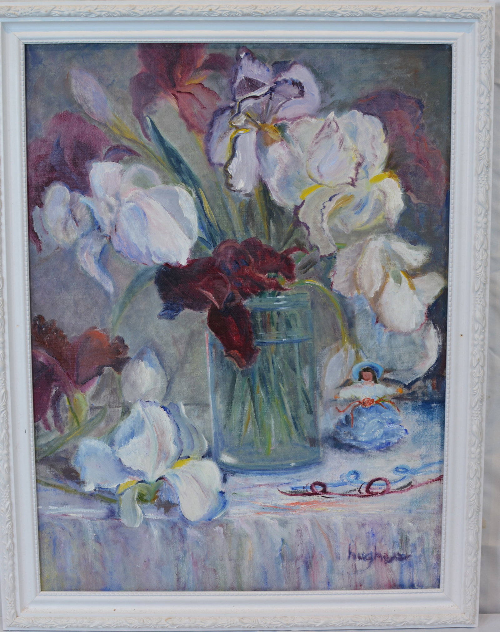 Signed Hughes Oil on Canvas Still Life of Irises in Glass Vase: Original oil on canvas still life painting signed "Hughes" lower right. The composition depicts a bouquet of white and burgundy irises arranged in a clear glass vase atop a draped tabletop,