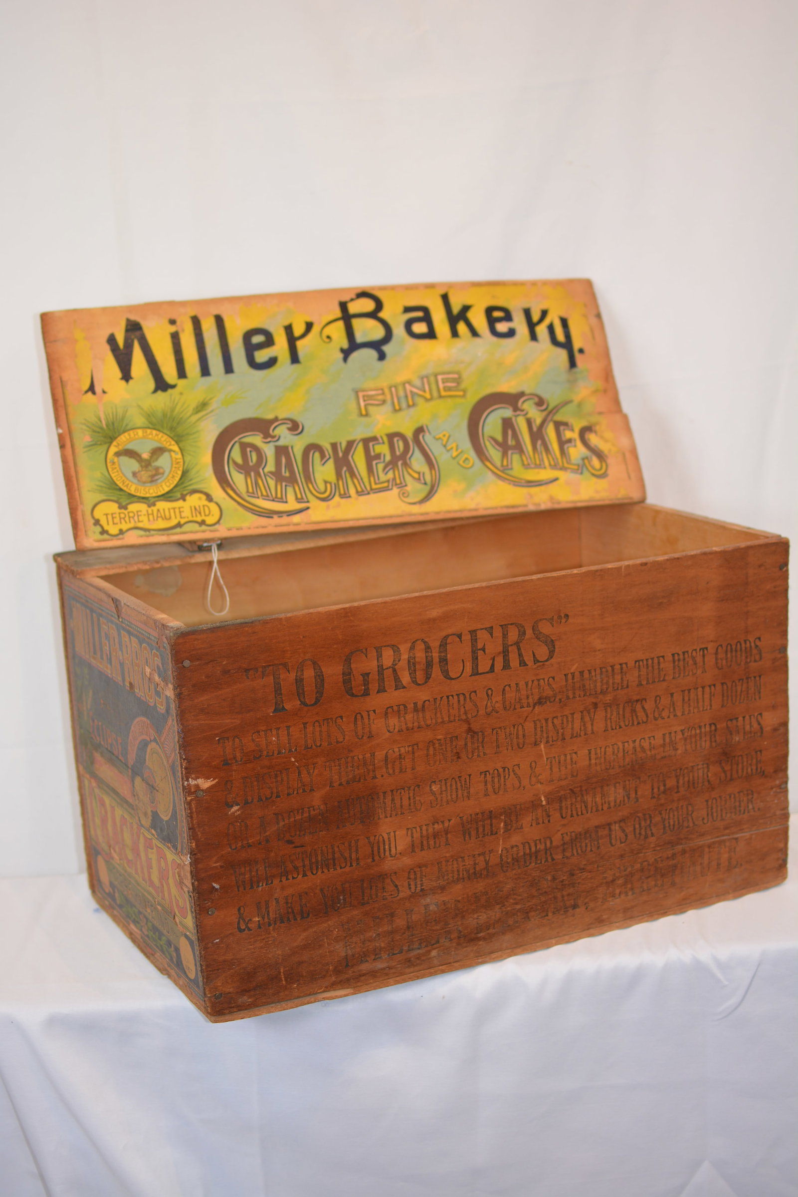 Miller Bakery Fine Crackers & Cakes Advertising: Miller Bakery advertising shipping crate from Terre Haute, Indiana. Constructed of wood with colorful lithographed side panels and retaining its original fold-up advertising show card reading "Miller