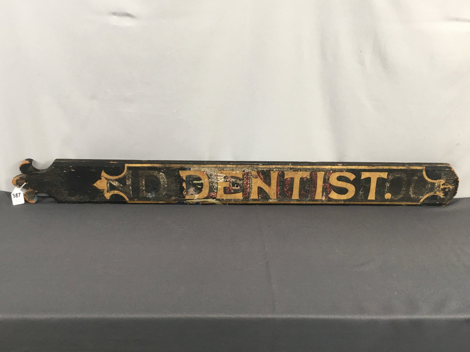 Wooden Dentist Trade Sign: Wooden Dentist Trade Sign, black with gold lettering. Has been over painted. 40.25"L x 4"H x 0.75".