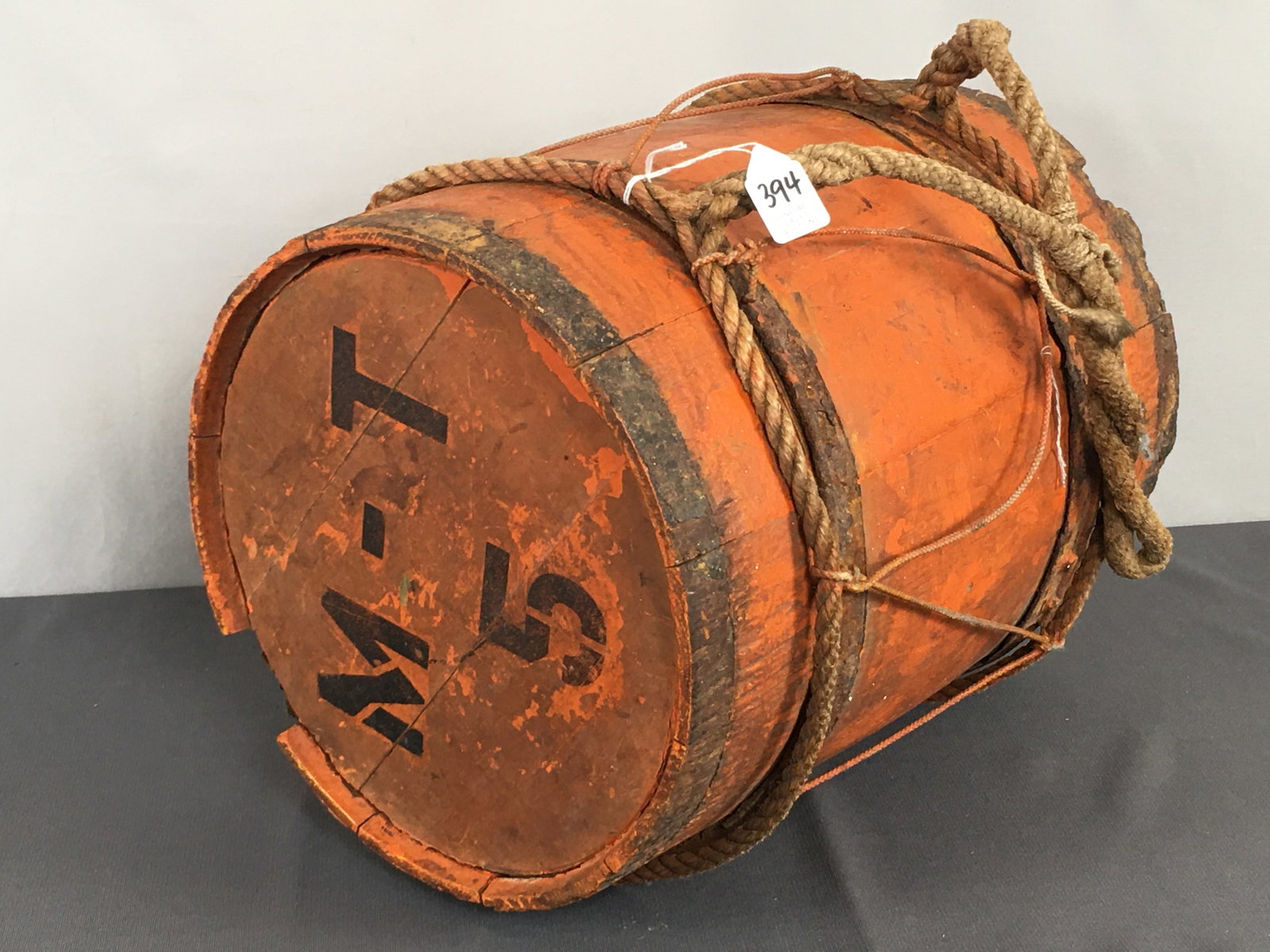 Water Keg in Orange Paint: Water Keg in Orange Paint, stenciled with M T 5 on each end and tied with a rope handle. 11"D x 14.5"H