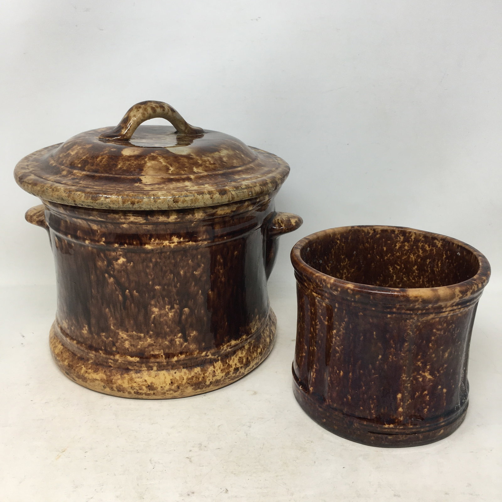2 Pieces Rockingham Pottery: 2 Pieces Rockingham Pottery. Double handled lidded crock and smaller utensil holder. Taller 8.5"H
