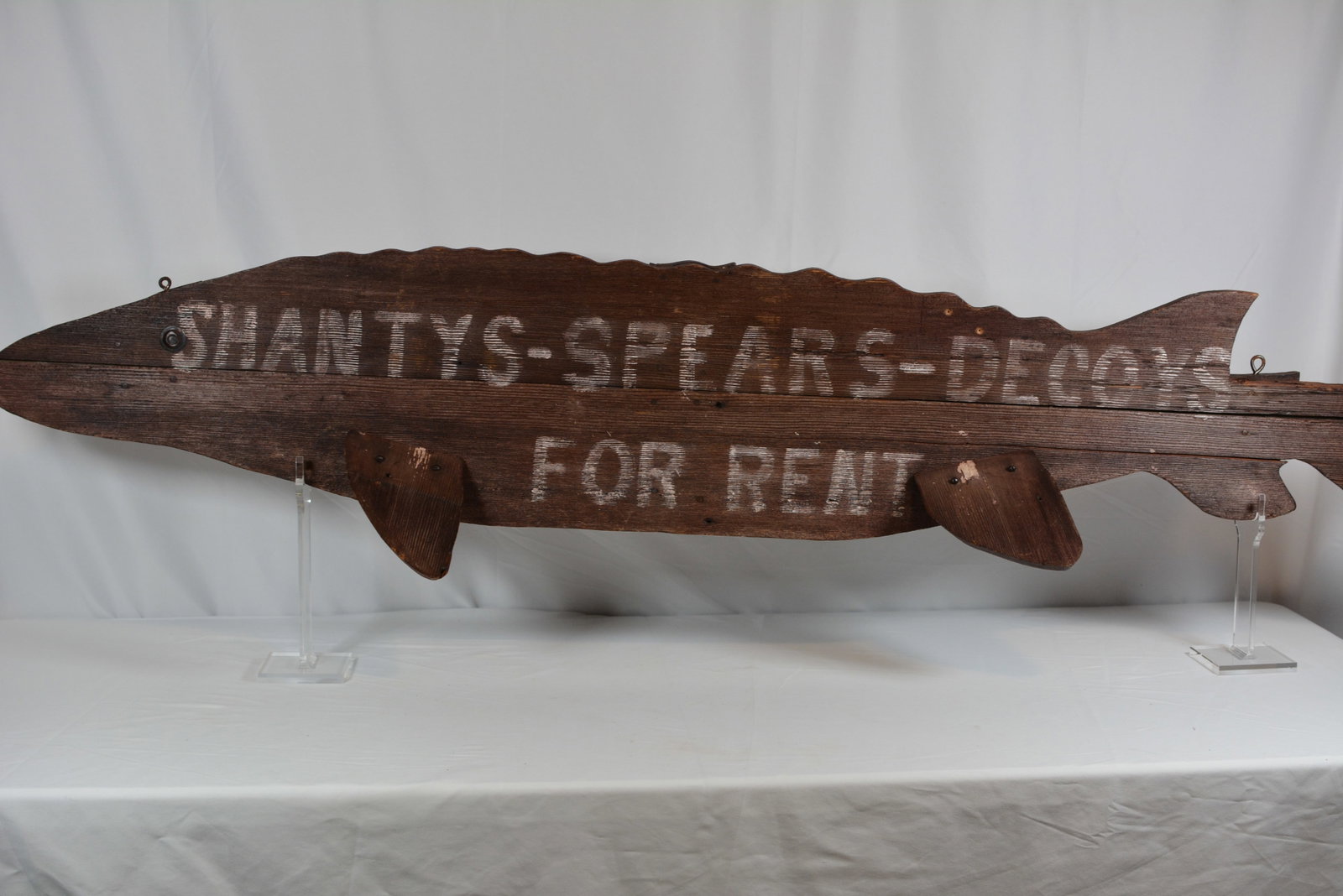 Large Folk Art Wooden Fish Shape Sign Swantys Spears Decoys for Rent Trade Sign: Large early folk art trade sign constructed in the form of a fish from joined wooden boards with applied fins, carved profile, and painted eye. The weathered surface retains hand-painted lettering