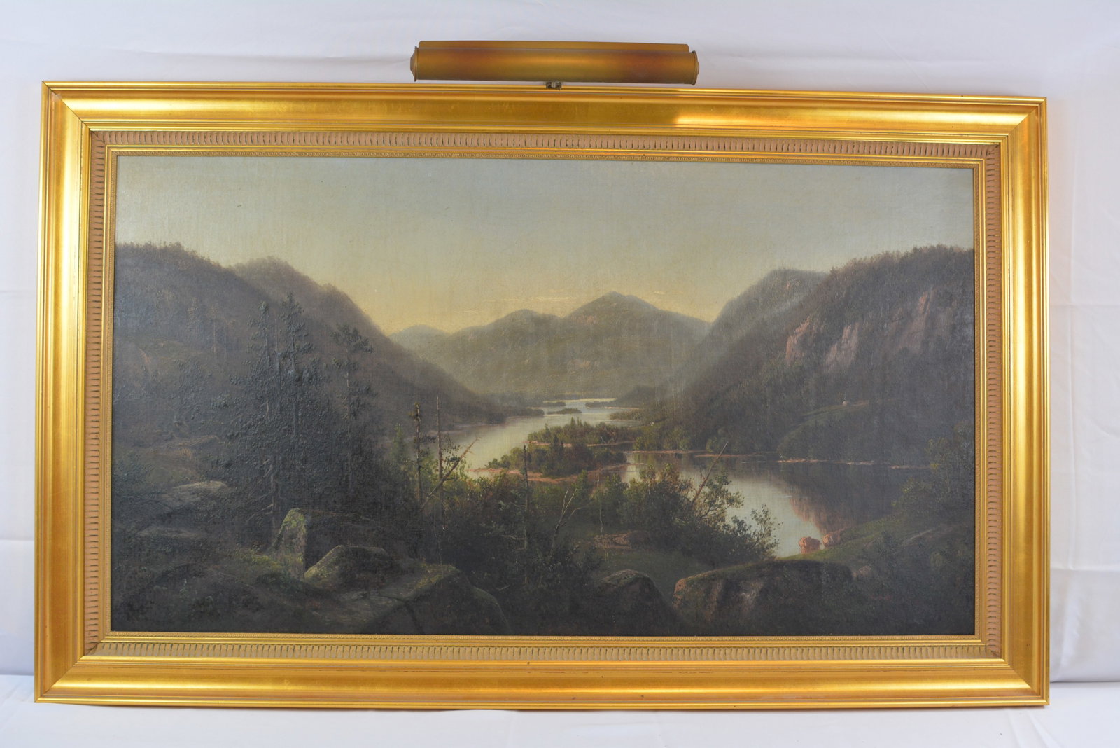 19th Century American Hudson River School Mountain Landscape Oil Painting: Large 19th century American landscape painting depicting a sweeping mountain and river valley with distant peaks, wooded slopes, rocky foreground, and calm water winding through the composition.