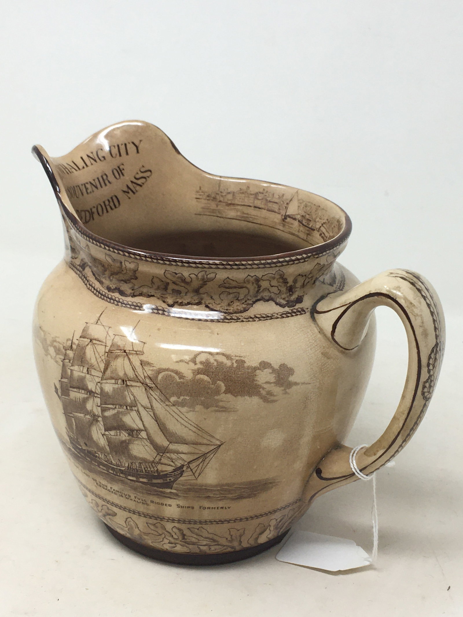 "The Whaling City" Buffalo Pottery Pitcher: "The Whaling City" Buffalo Pottery Pitcher, Souvenir of New Bedford Massachusetts. With brown transferware scenes featuring sperm whaling, "The Capture"; and The Niger whaling ship. Bottom marked Buff