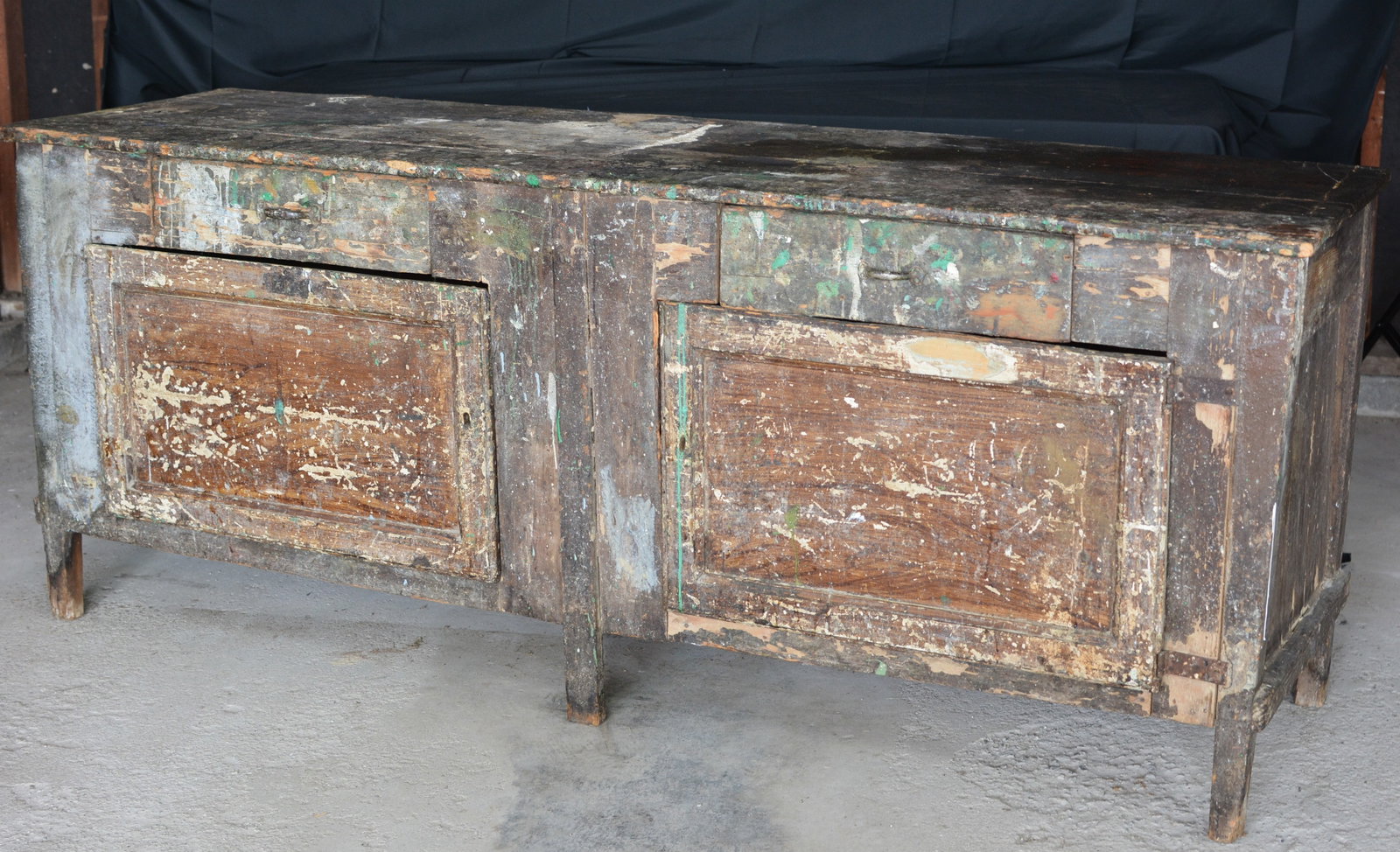 19th Century Artist's Paint Cupboard-Studio Work Cabinet: Unusual 19th century wooden artist's paint cupboard and studio work cabinet, featuring a long work surface above two paneled cupboard doors with small upper drawers. The cabinet retains an