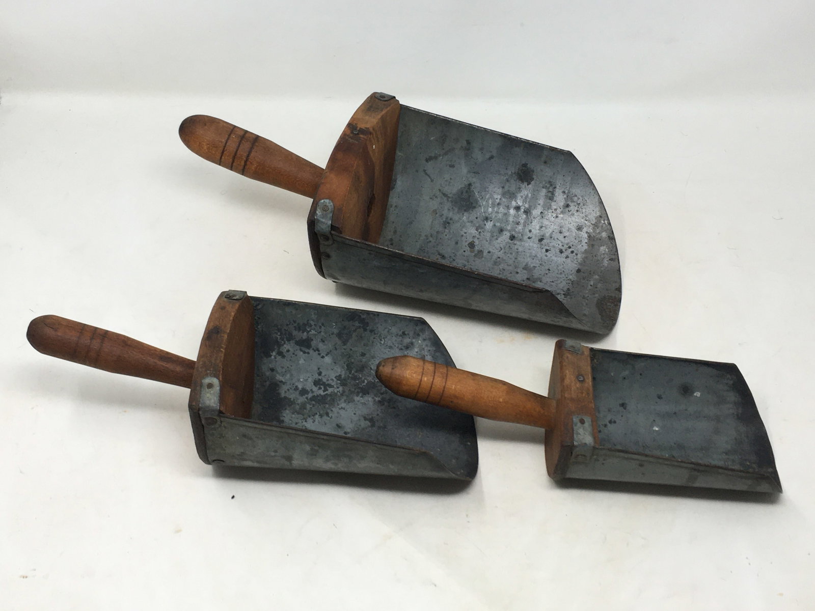 Graduated Wood & Metal Grain Scoops: Graduated Wood & Metal Grain Scoops. Stamped on back Tawco Brand 1, 2, 4. Largest 6"W x 12.25"L
