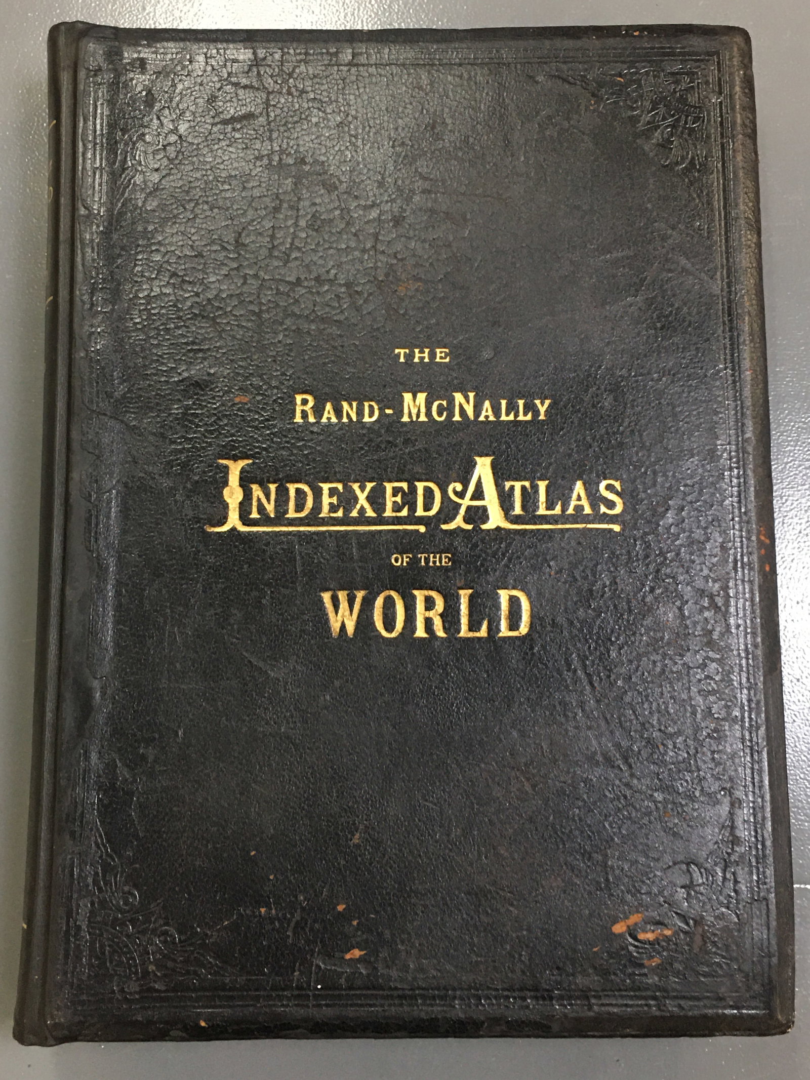 1892 Rand McNally Indexed Atlas of the World: 1893 Rand McNally Indexed Atlas of the World. Good binding, some staining/discoloration to pages and some cracking to leather cover. 16.5"W x 22.75"H x 3"D.
