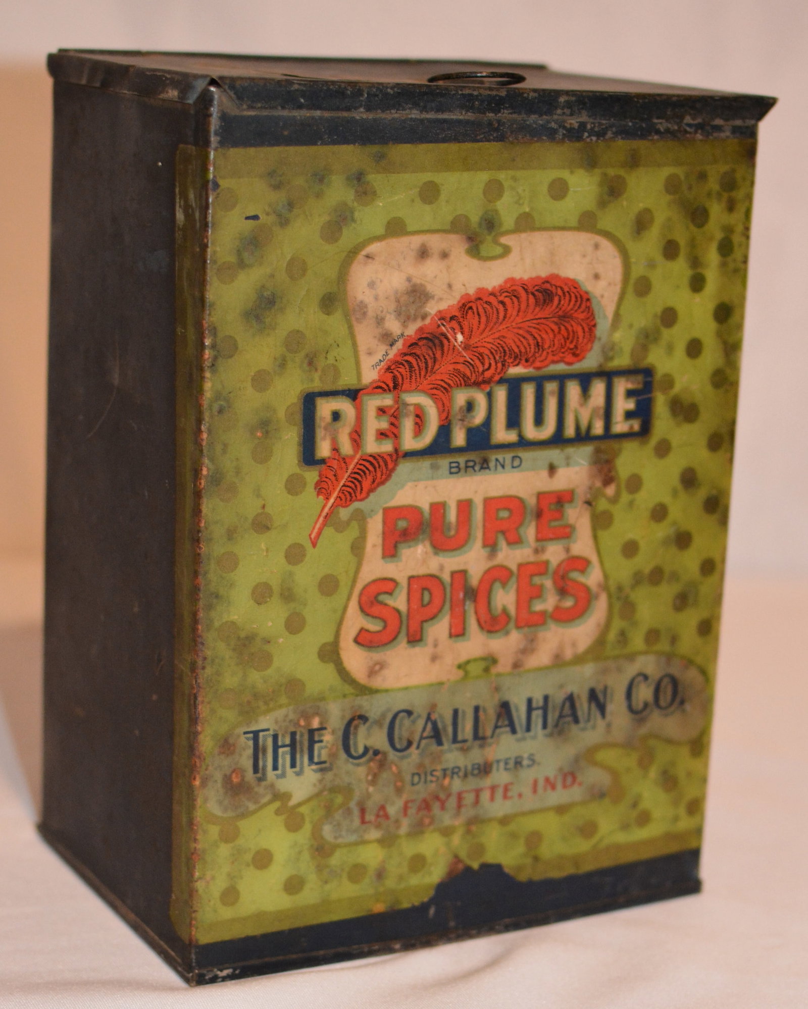 Red Plume Pure Spices Advertising Tin-C. Callahan Co., Lafayette, Indiana: Early Red Plume Brand Pure Spices lithographed advertising tin featuring a colorful red feather trademark and green patterned background. Marked "The C. Callahan Co., Distributers, La Fayette, Ind."