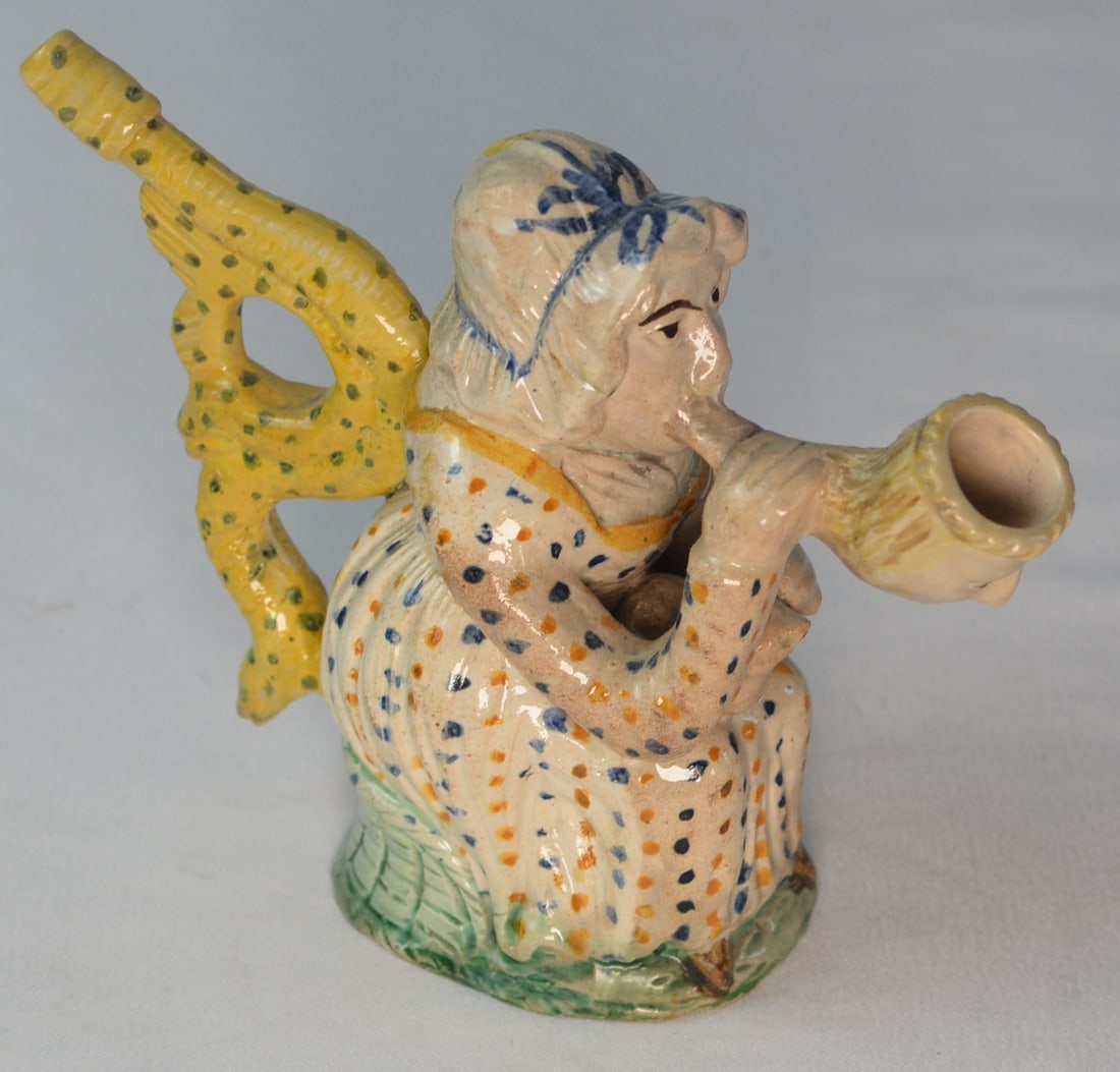Rare c.1810 Staffordshire Martha Gunn Figural Pipe: Rare early 19th century Staffordshire figural pipe modeled as Martha Gunn, the celebrated Brighton bathing woman, depicted seated and smoking a large pipe with a boldly modeled yellow openwork chair b