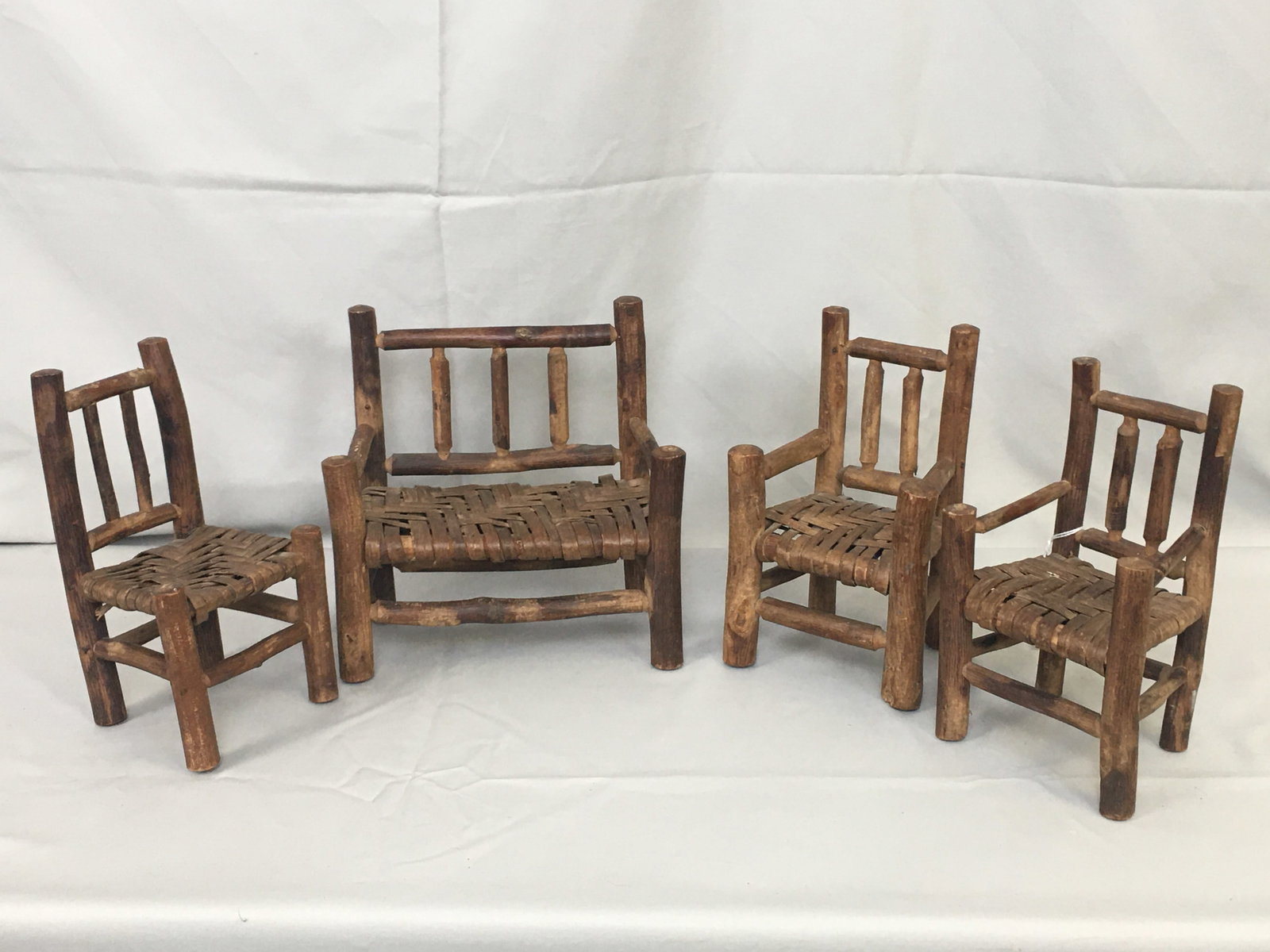 Rustic Hickory Miniature Chairs: Rustic Hickory Miniature Chairs. 3 chairs and a settee, with woven seats. 3 are marked on bottom "1914 Slack(?) Estate, Calif. Approx 8.5"H.