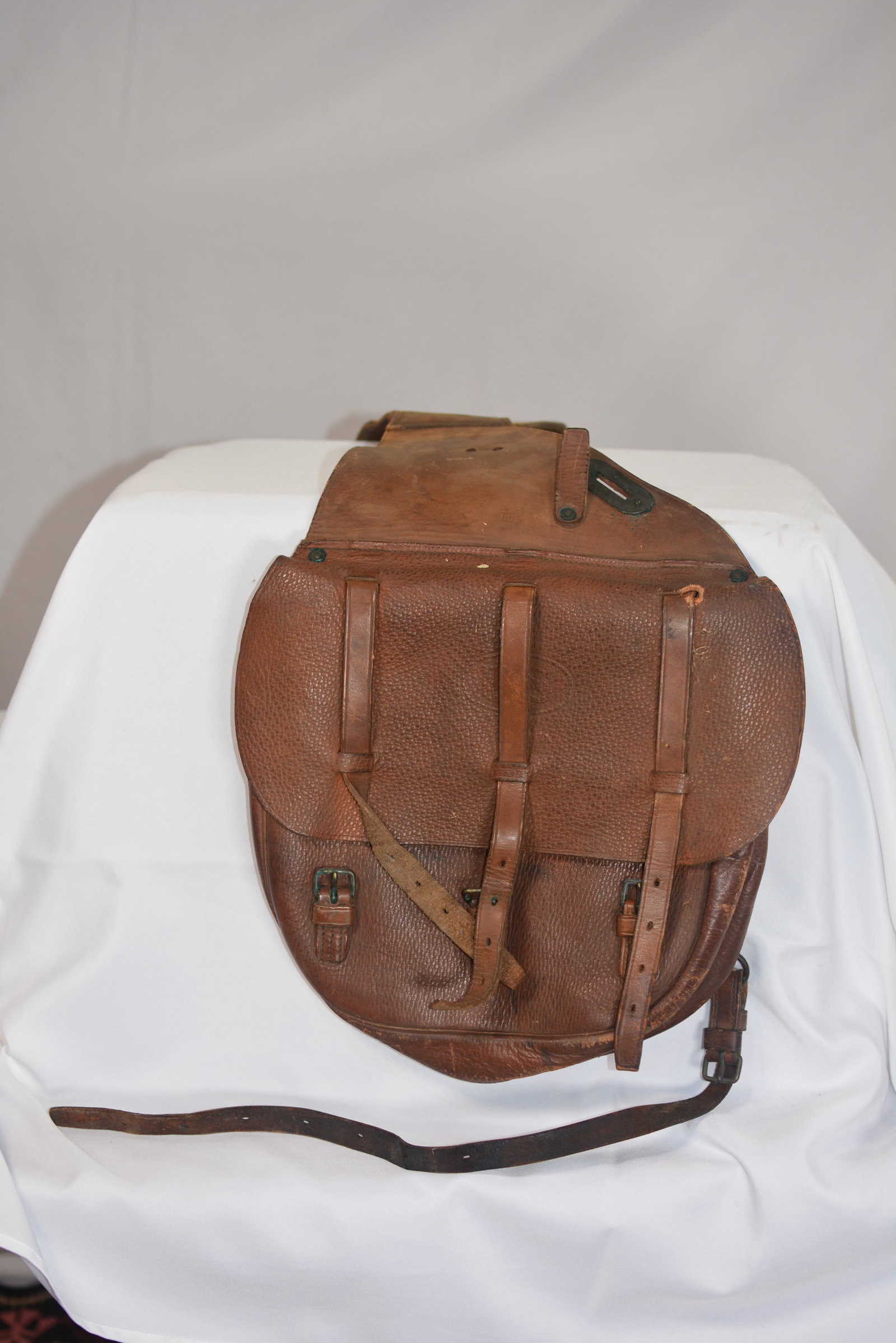 U.S. Military Leather Cavalry Saddle Bags: Early U.S. military-style leather cavalry saddle bags constructed of heavy pebbled brown leather with three buckle straps across the flap and additional attachment straps and hardware. Saddle bags