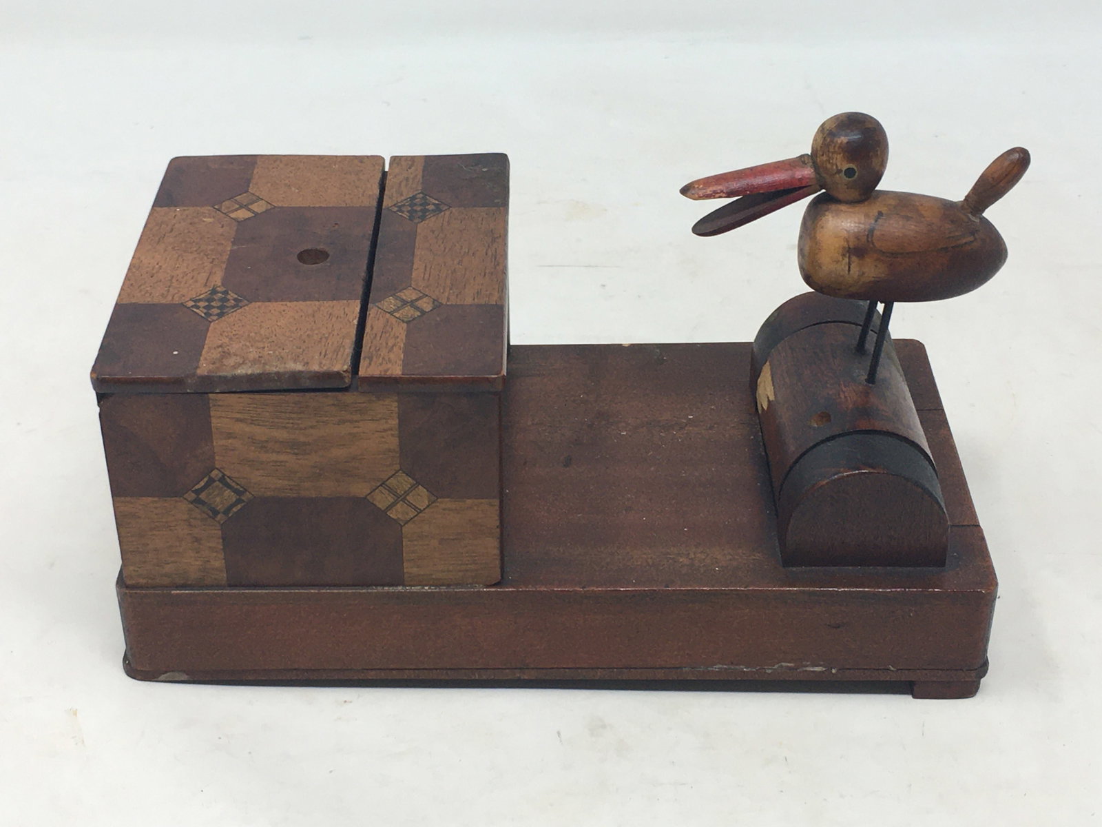 Folk Art Cigarette Dispenser: Folk Art Wooden Cigarette Dispenser. Inlaid box for cigarettes, top lifts off to load cigarettes, and when the bird is pushed forward, the drawer opens for him to retrieve one. Missing one wooden