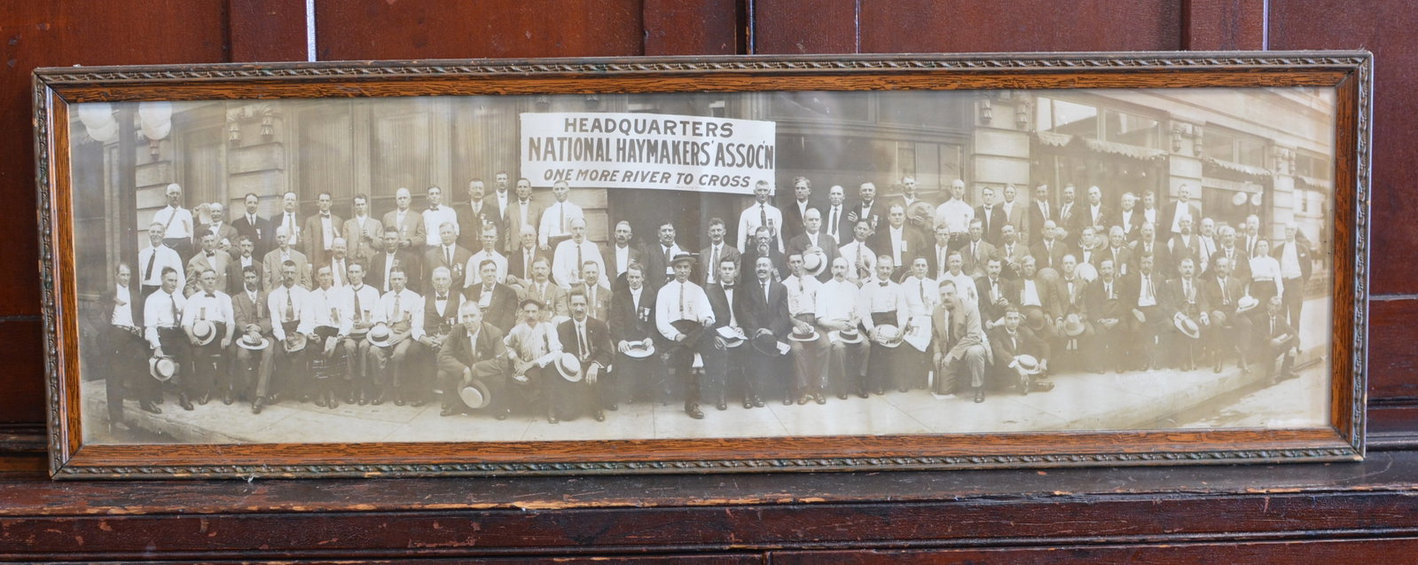 Early National Haymakers Association Panoramic Group Photograph: Large early 20th-century panoramic group photograph depicting members of the National Haymakers Association gathered outside their headquarters, with a prominent banner reading "HEADQUARTERS NATIONAL 