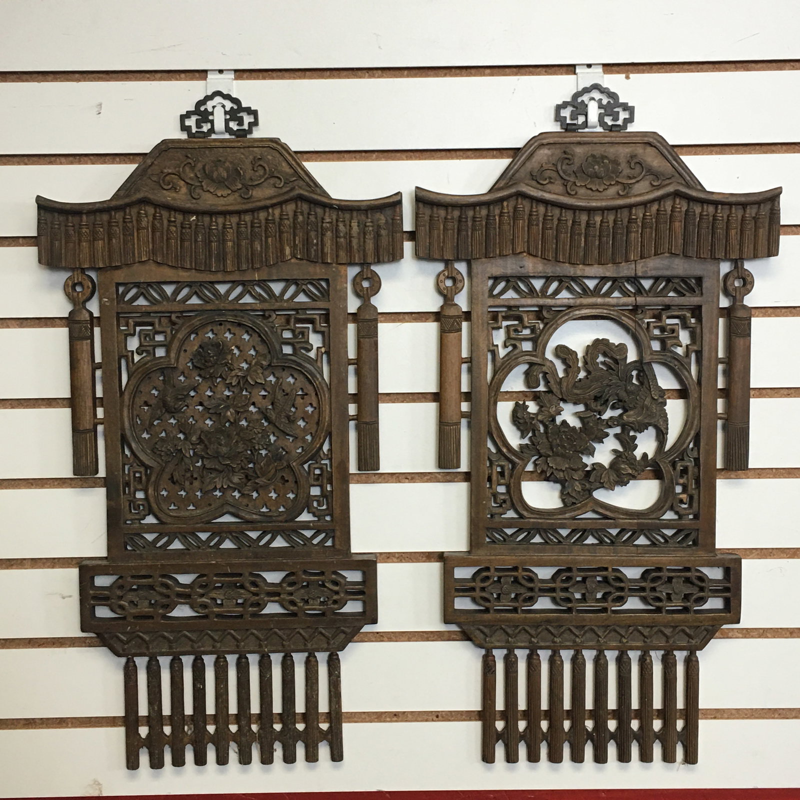 Two Fretwork Pieces: Two Fretwork Pieces. Hanging tassels around a central floral motif. 13" x 25"