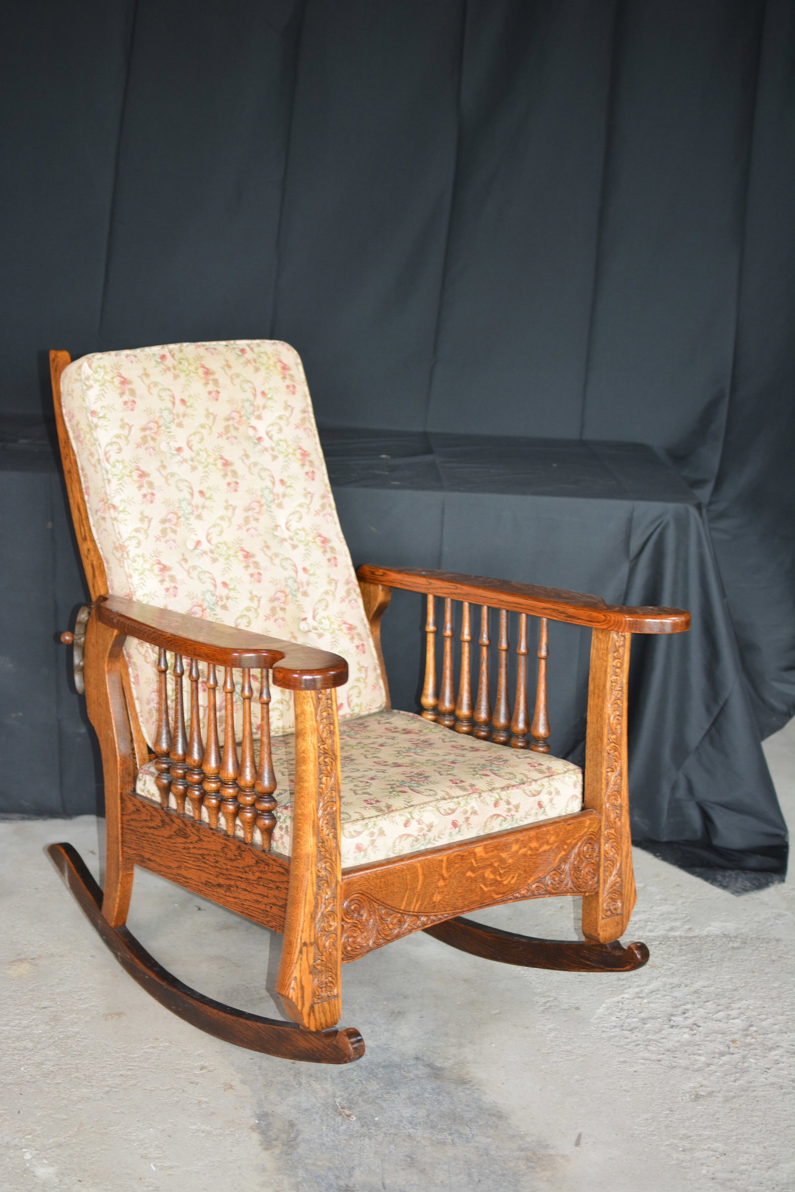 Antique Oak Platform Rocker with Adjustable Back: Antique oak platform rocking chair featuring an adjustable reclining back, carved frame, turned spindle sides, and shaped wooden arms. The chair displays attractive quarter-sawn oak grain with carved 