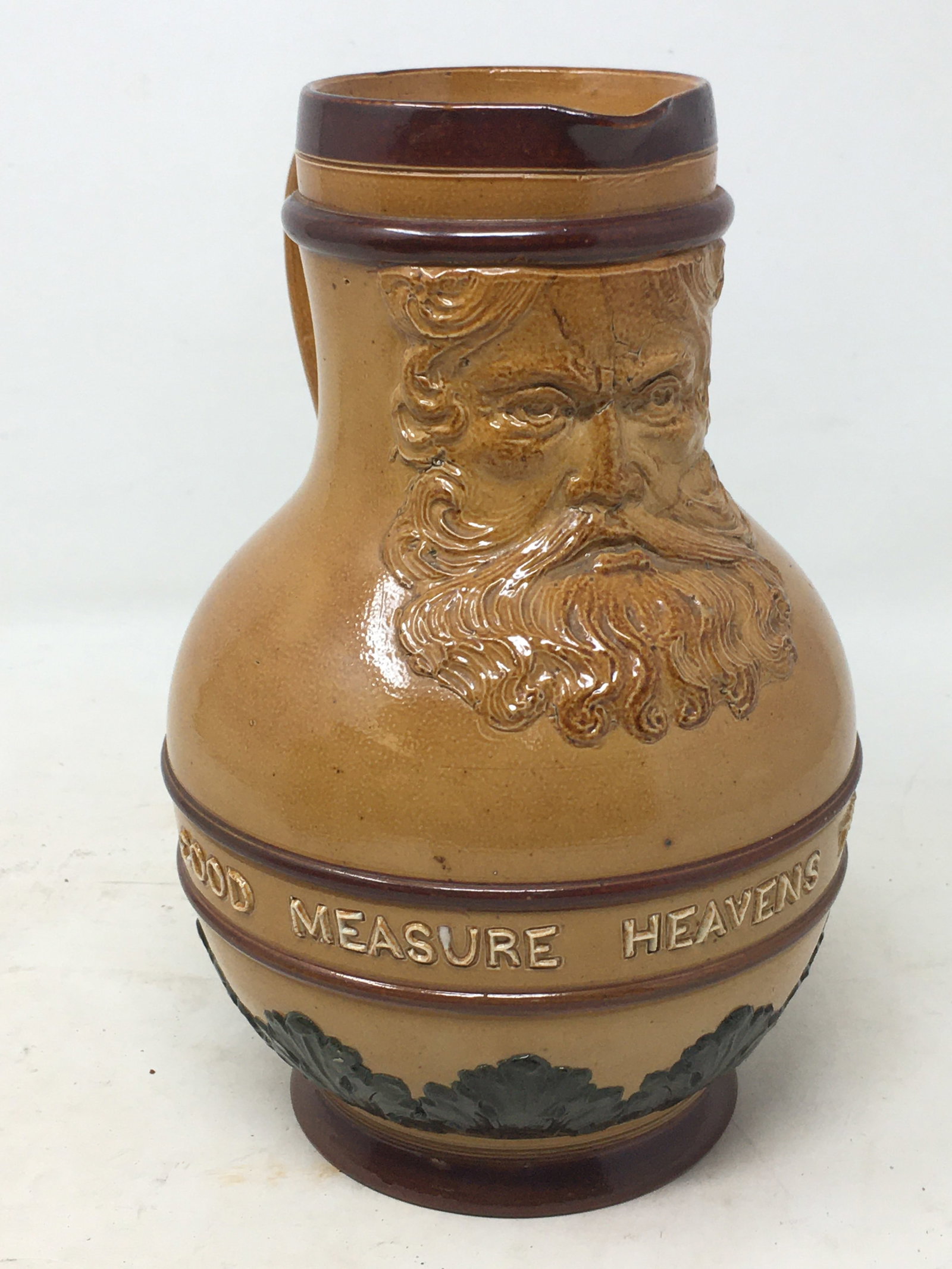 Doulton Lambeth Motto Pitcher: Doulton Lambeth Motto Pitcher. "Good Measure Heaven's Treasure", featuring North Wind face. 8"H.