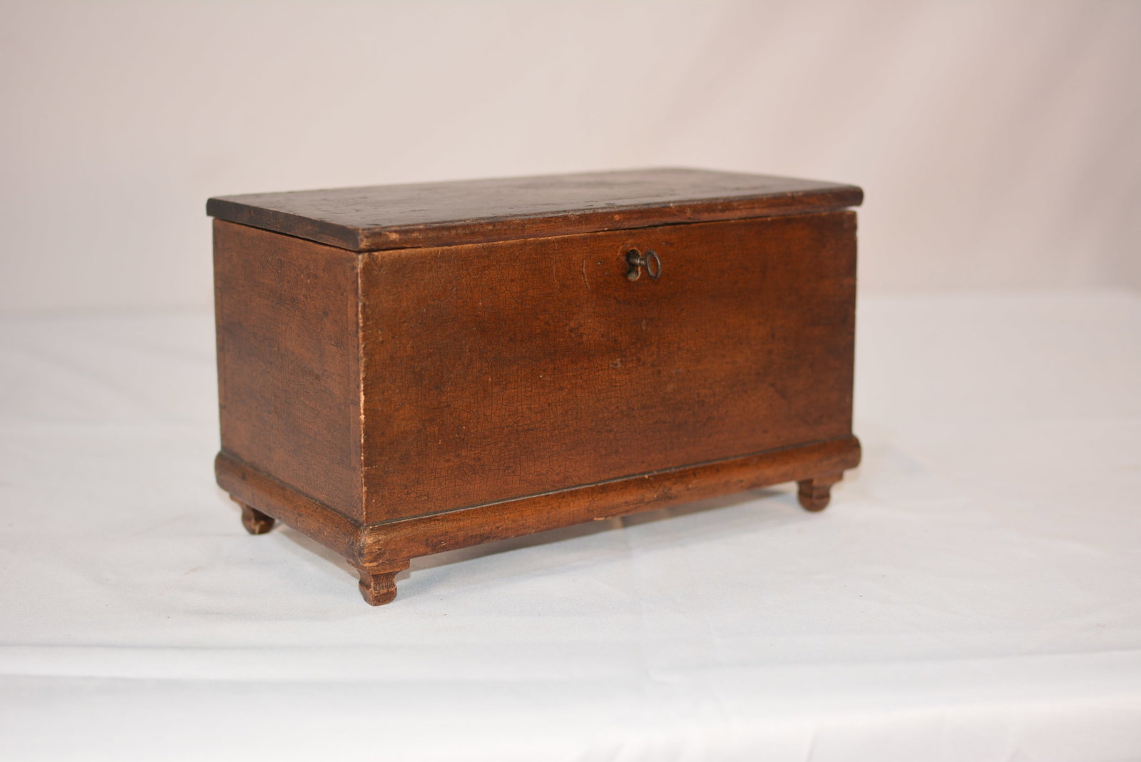 Antique Wooden Keepsake Box: Antique wooden keepsake box featuring a hinged lid with a decorative portrait decal on the interior.