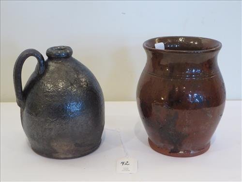 Redware quart size ovoid redware jug: Redware quart size ovoid redware jug w/ dark glaze and quart size redware ovoid jar, jar has some crow's feet on side, jug has a oval glaze slip, jar has dark splotches, jug 6" t. , jar 4 1/2" x 6", $