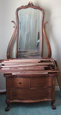 36. Antique serpentine front mahogany claw foot commode: Together with beveled mirror. Measures 6 foot tall to top of mirror. One drawer pull Missing