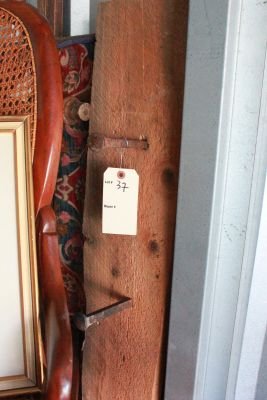 37. Primitive wall mounted coat hanger: made of old wood and railroad spikes. Measures 65 inches long.