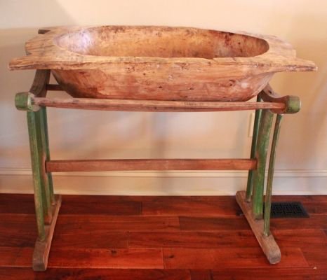 54. Vintage hand carved dough bowl on stand. Mexician: features dough bowl carved out of one piece of wood on a green painted stand. Measures overall 33 inches tall x 38 inches wide x 20.5 inches deep.
