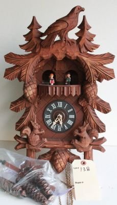 138. Vintage German cuckoo clock.: Squirrels move to the sound of the chimes, together with pendulum and weights. Measures 22" from top to bottom of case.