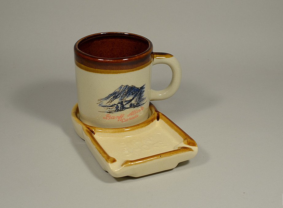 Ceramic Banff, Alberta CANADA : SIP & SMOKE - Cup and: DESCRIPTION: Ceramic Banff, Alberta CANADA : SIP & SMOKE - Cup and Ashtray - Back view of MT. RUNDLE Transfer printed & painted. CONDITION: Very good vintage condition. Tray shows some 'crazin