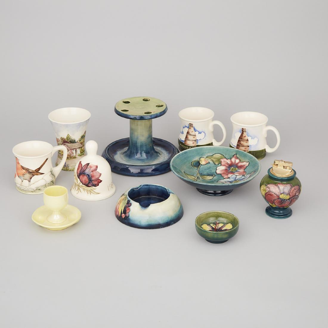 Group of Moorcroft Pottery, 20th century: Lot 196 Group of Moorcroft Pottery, 20th century comprising: 3 mugs, table bell, shallow bowl, egg cup, nut dish, small vase, ashtray, table lighter, and pipe stand pipe stand height 5.1 in — 13 cm