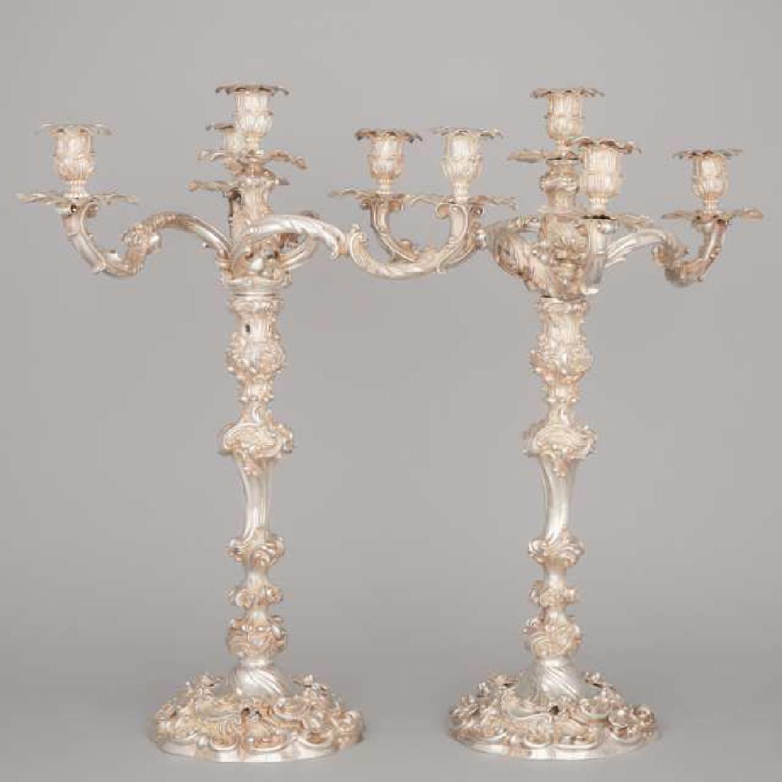 A Massive Pair of Victorian Cast Silver Four-Light: Lot 65 A Massive Pair of Victorian Cast Silver Four-Light Candelabra, Robert Garrard II, London, 1854 with multi-knopped stems, each supporting a branch section of three foliate scroll arms and a cent