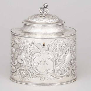 George III Silver Tea Oval Caddy, Miles Askew, London,: Lot 77 George III Silver Tea Oval Caddy, Miles Askew, London, 1785 the straight sides and domed cover chased with rococo scroll and shell cartouches surrounded by flowers and exotic birds amongst scro