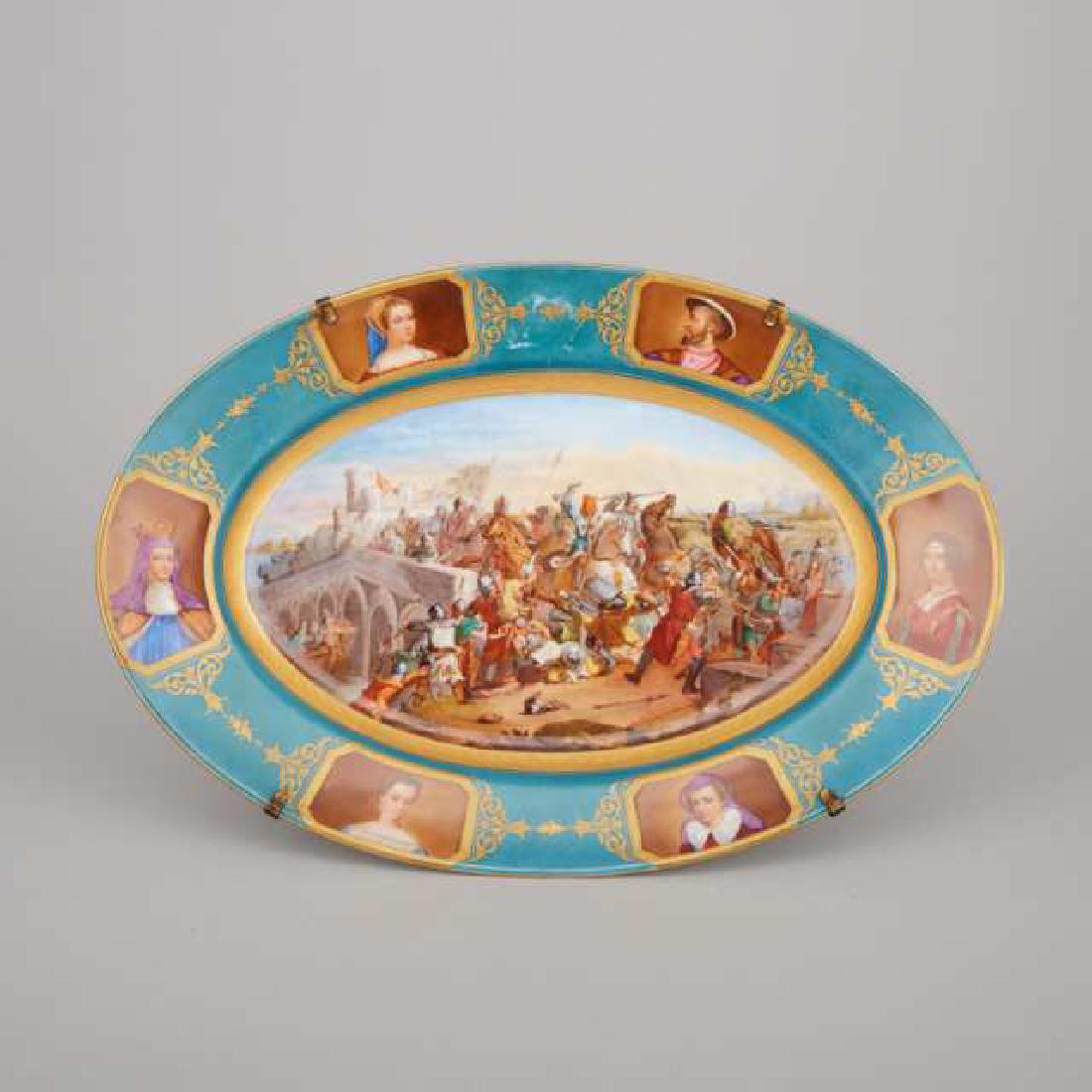 'Sèvres' Oval Platter, c.1900: Lot 182 'Sèvres' Oval Platter, c.1900 painted in colours on the centre with a battle scene at Taillebourg, after Adam Frans van der Meulen, the blue ground rim reserved six portraits within gilt surr
