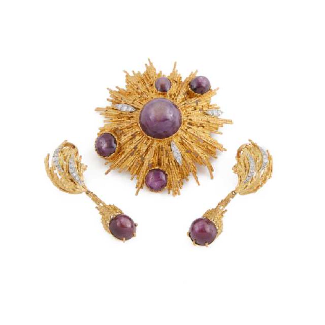 Grima 18K Yellow Gold Spray Brooch And Drop Earrings: Lot 116 Grima 18K Yellow Gold Spray Brooch And Drop Earrings bezel set with a total of 7 star ruby cabochons and 27 small single and brilliant cut diamonds 57.3 grams London 1975 Estimate $2,000-$3,00
