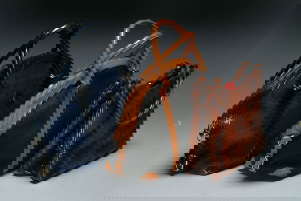 Fashion Three Designer Day Bags: Three Designer Day Bags two Guy Laroche monogrammed canvas day bags in blue and black together with a mottled patent leather Holtzman purse with bakelite fittings [3], Guy Laroche 12 x 10"; Holtzman 1