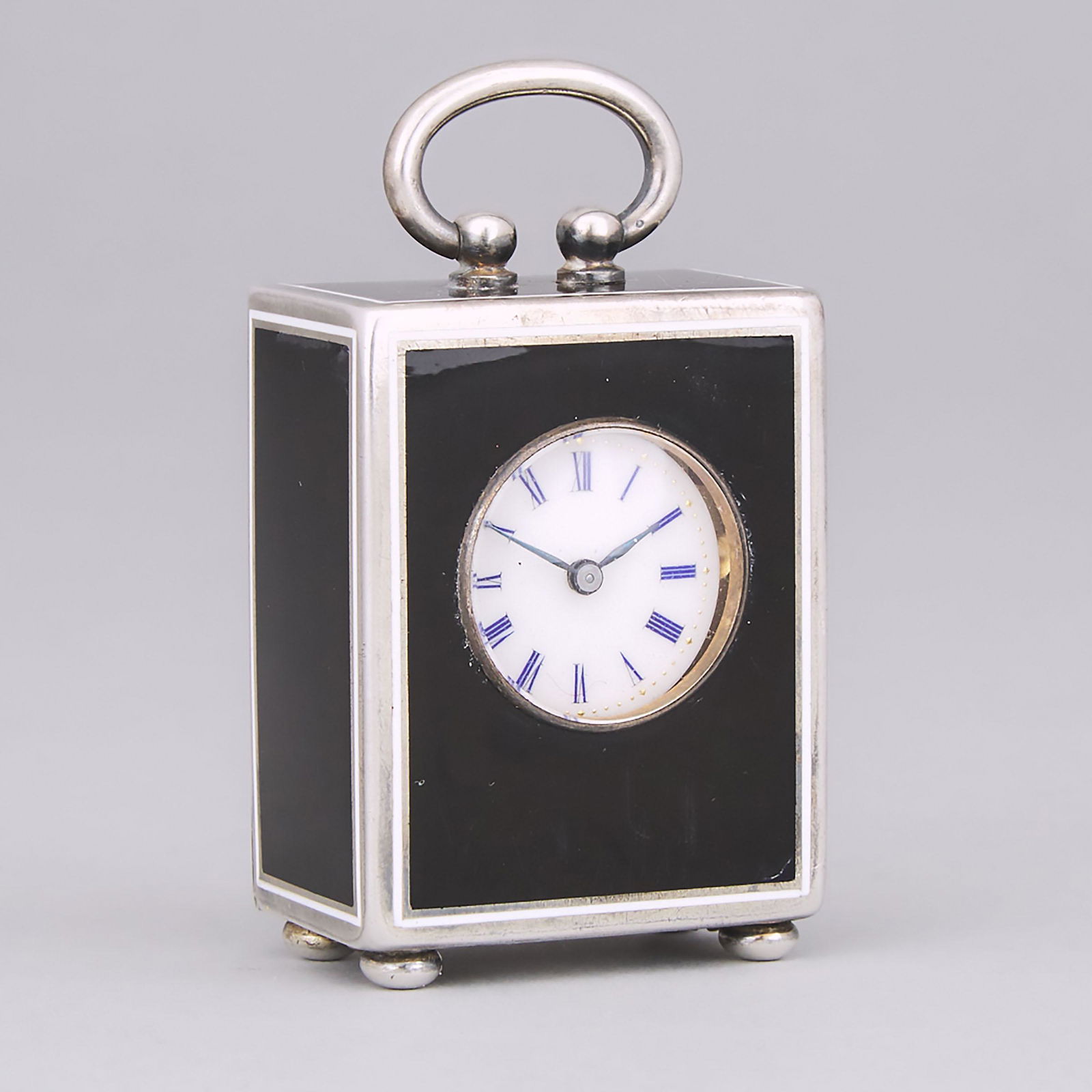 Continental Black and White Enameled and Engraved: Continental Black and White Enameled and Engraved Silver Cased Miniature Desk Clock, probably Swiss, early 20th century height 2.2 in — 5.5 cm Estimate: $150—250