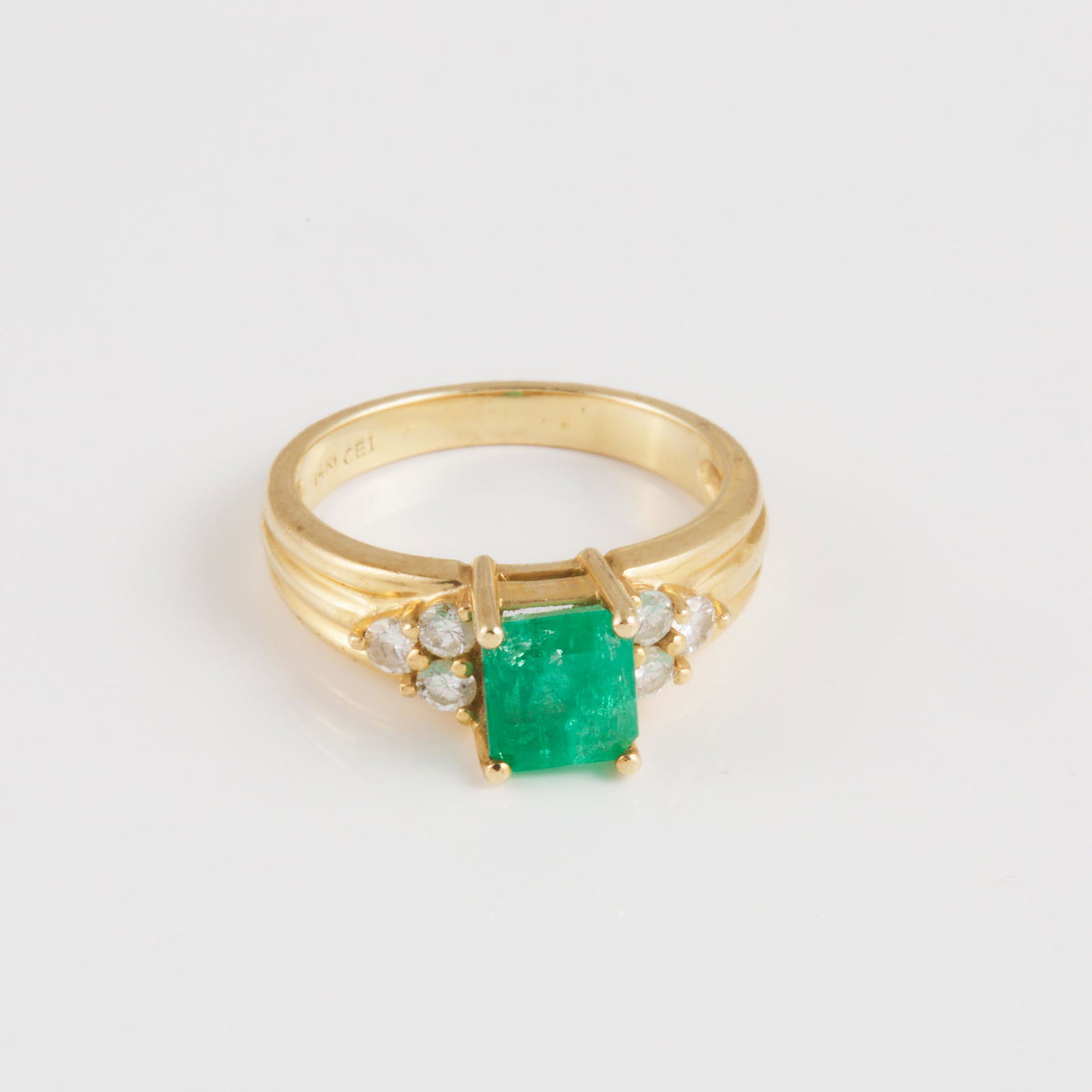 14k Yellow Gold Ring, set with an emerald cut emerald (appr: 14K YELLOW GOLD RINGset with an emerald cut emerald (approx. 1.25ct.), and 6 small brilliant cut diamonds, size 6 3/4, 4.7 gramsEstimate: $400—600