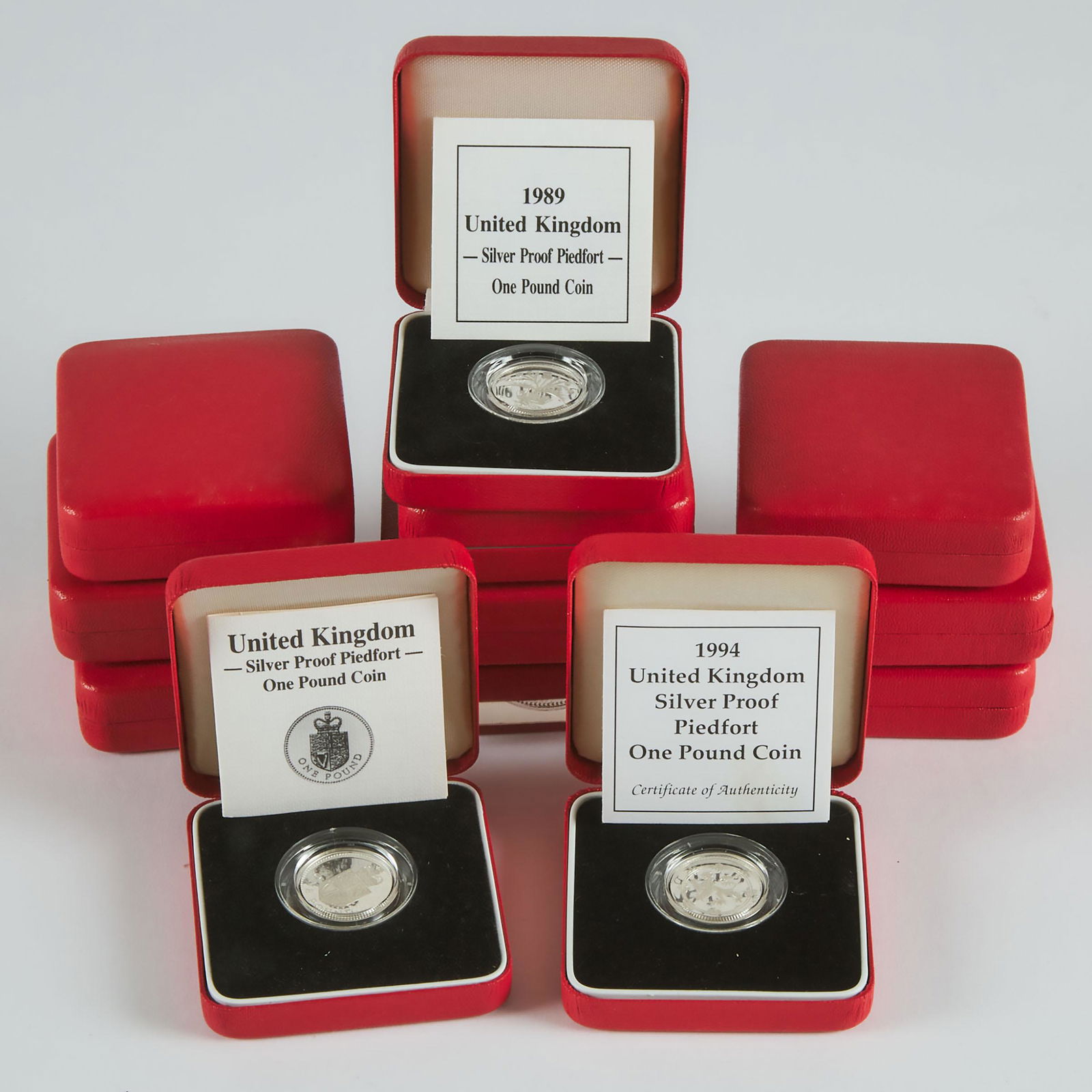 12 British Sterling Silver Proof One Pound Coins, in cases,: 12 BRITISH STERLING SILVER PROOF ONE POUND COINSin cases, assorted yearsEstimate: $200—300