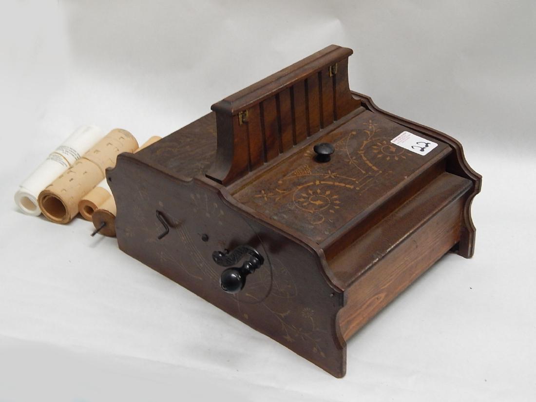 Antique Roller Organ & Paper Rolls: Antique hand crank roller organ with paper rolls. Untested belows and needs repairs to wood body.. Measures 16" x 14"