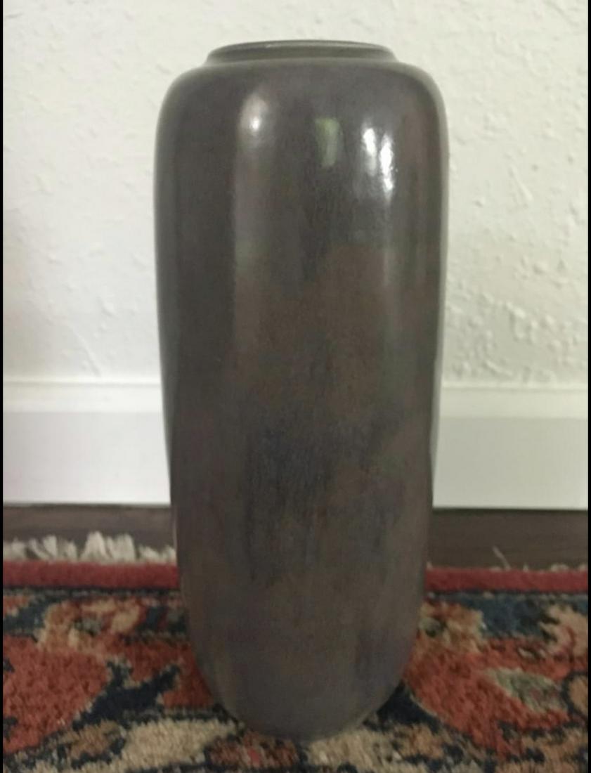 A&C tall vase: Handsome Arts & Crafts form in a blue/brown high glazs. Unmarked. Attributed to Roseville Luster or Roseville Rosecraft line. Dimensions: 8”H X 4”W