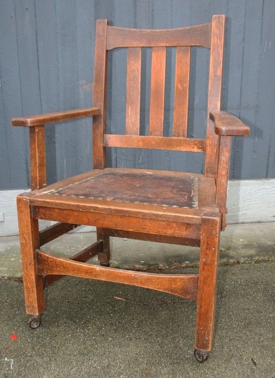 Stickley Brothers Office Arm Chair: Original finish with arms and trumpeted front stretcher.38” High 23”(Seat) 18” Across (Back) original leather seat and wheels. Unsigned.