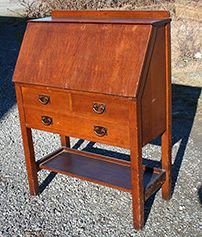 Gustav Stickley Drop Front Desk: Gustav Stickley three drawer drop front desk with original pulls and original finish. Signed in drawer and paper label on back. Repaired veneer chips around lid and repaired veneer on interior.