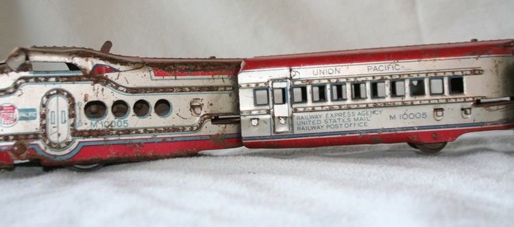 Union Pacific Metal Wind-UP Train: Complete vintage four unit metal wind-up toy. Weathered original paint. Each car 8”long x 5” High x 3.5” Deep.