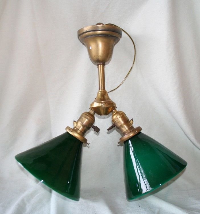 Rare interurban trolley Light w/ 2 Green Shades: Vintage trolley or train ceiling fixture. 15” High. Unusual sockets with set screws to secure light bulbs in a moving, vibrating interior. Vintage 6” cased green shades.