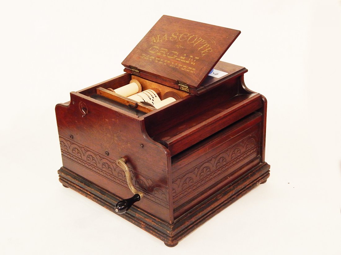 Mascotte Paper Roller Organette Walnut Case: Mascotte paper roller organette by Gately Mfg. Co. Pressed carved walnut case. Fine working condition. 13" x 14" x 11"