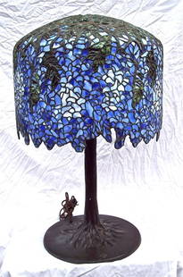 STUDIO MADE & DESIGNED WYESTRIA LEADED GLASS TABLE LAMP: THS IS THE MATCH LOT # 20 -- 29" TALL ON A 14" HEAVY BRONZE BASE. THIS LAMP IS A STUDIO DESIGN, HIGH QUALITY, LEADED GLASS IN THE STYLE OF TIFFANY. THE BASE IS ALL BRONZE WITH A TREE BARK THIS LAMP IS