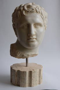 CLASSICAL GREEK HEAD: Classical head carved on white Carrara marble placed on a travertine base, (section of a fluted column). the head is inspired by the famous sculpture of Lysippos. Base measures included