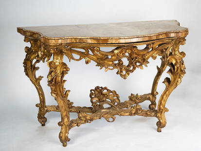 Large console: Large Roman console in gilded wood and richly carved with rocailles, leafy scrolls and floral motifs. Alabaster marble top. YOU CAN REQUEST FURTHER PHOTOS AND INFORMATION VIA EMAIL. Contact us to