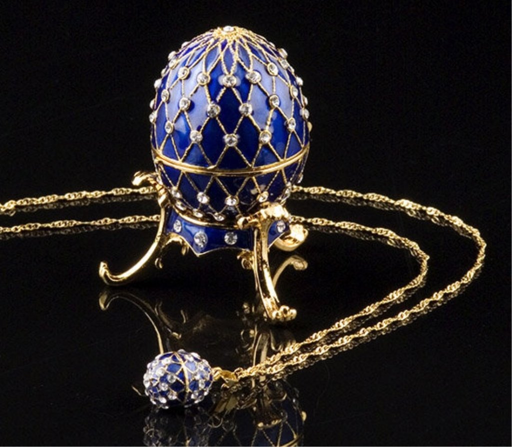 Russian Style Jeweled Egg Box w/ Necklace: Spectacular Egg reminiscent of Russian Faberge eggs, feature bright, enameled color decorated with crystal jewels. The egg rests on a similarly decorated three-footed stand. The unique, magnetic, hing