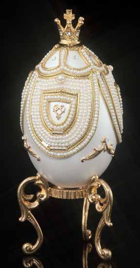 Decorative Swarovski Crystal Carousel Egg: The pearl white egg has three pearl-trimmed pull down bridges with windows inviting you to take a summer ride. Lower the bridges for a full view of the carousel inside, or lower just the windows to vi